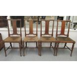 A set of four William Morris & Co oak framed tabard style dining chairs, designed by Richard