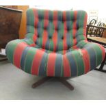 A 1960s/70s tub design chair, rotating on a teak base