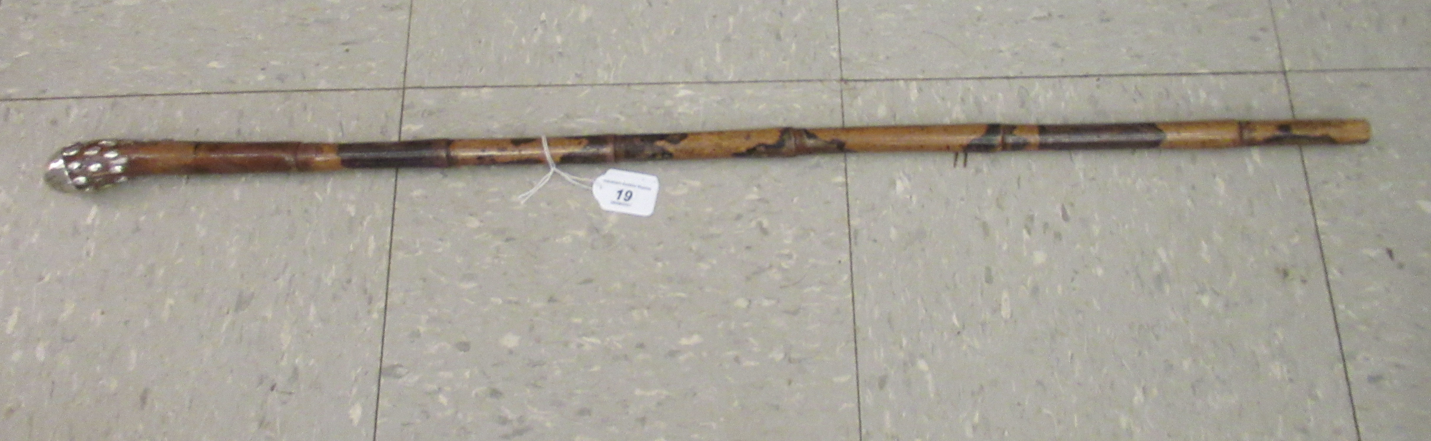 An early/mid 20thC turned wooden walking cane with white metal ornament