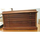 A modern mahogany coin collectors chest, comprising six graduated drawers, each with an unfitted