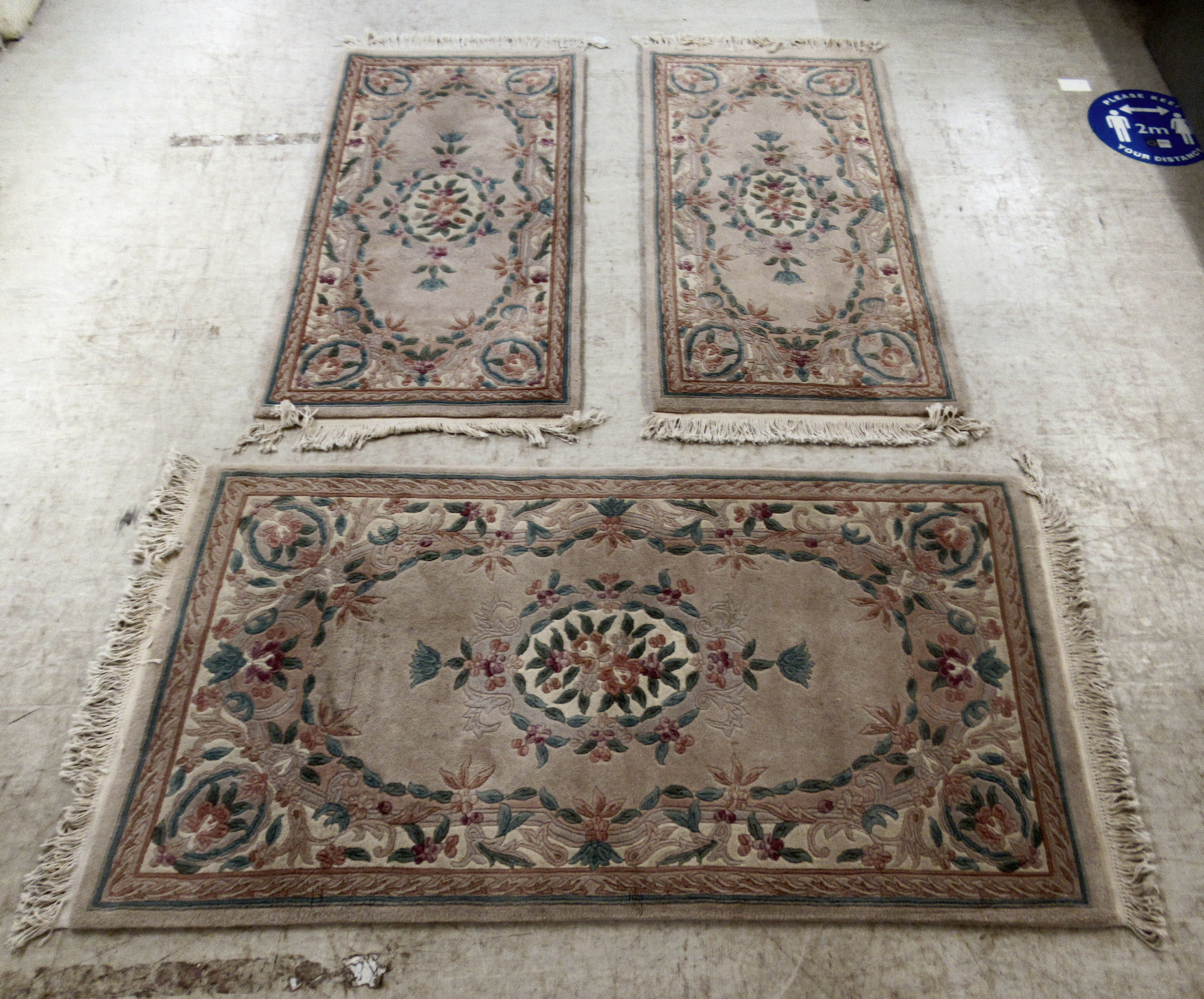 Three identical Chinese cotton rugs, decorated in pastel shades with floral designs  36'' x 60'' and