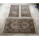 Three identical Chinese cotton rugs, decorated in pastel shades with floral designs  36'' x 60'' and