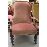 A mid Victorian mahogany showwood framed, open arm salon chair, raised on baluster forelegs and