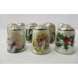 Eleven enamelled white metal thimbles, mostly decorated with wildlife