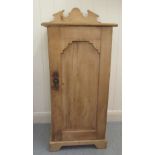 A late Victorian pine bedside cabinet with a single door, on a plinth  29''h  15''w