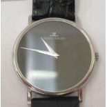 A Jaeger Le Coultre mechanical stainless steel cased wristwatch, faced by a plain black dial