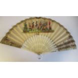 A 19thC fan with carved and inked bone sticks, the folding paper leaf painted on both sides with