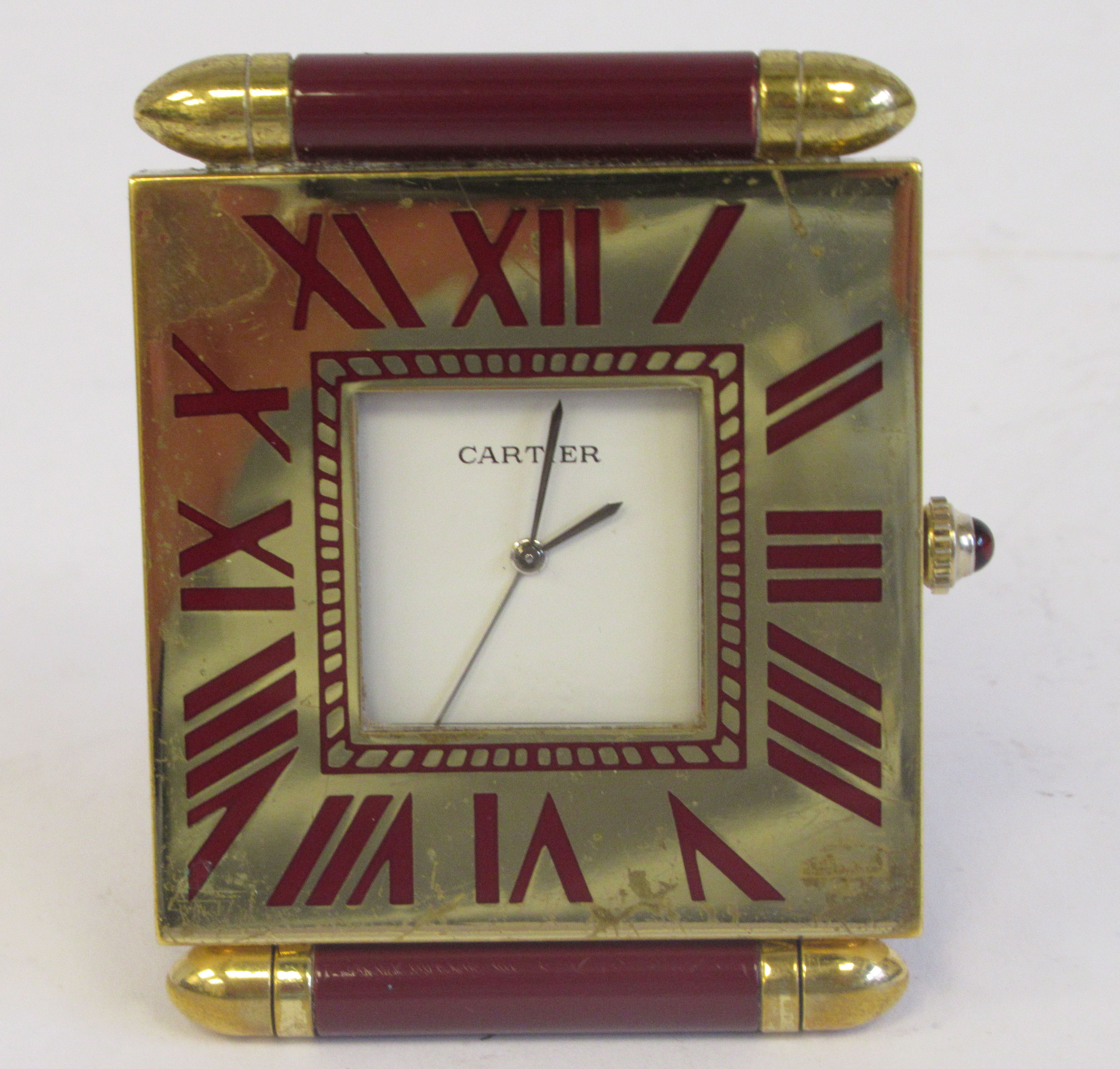 A Cartier Swiss made traveller's lacquered gilt metal cased timepiece of slim, square form with a