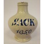 An early 19thC cream coloured Pearlware wine bottle of squat, bulbous form with a narrow neck and