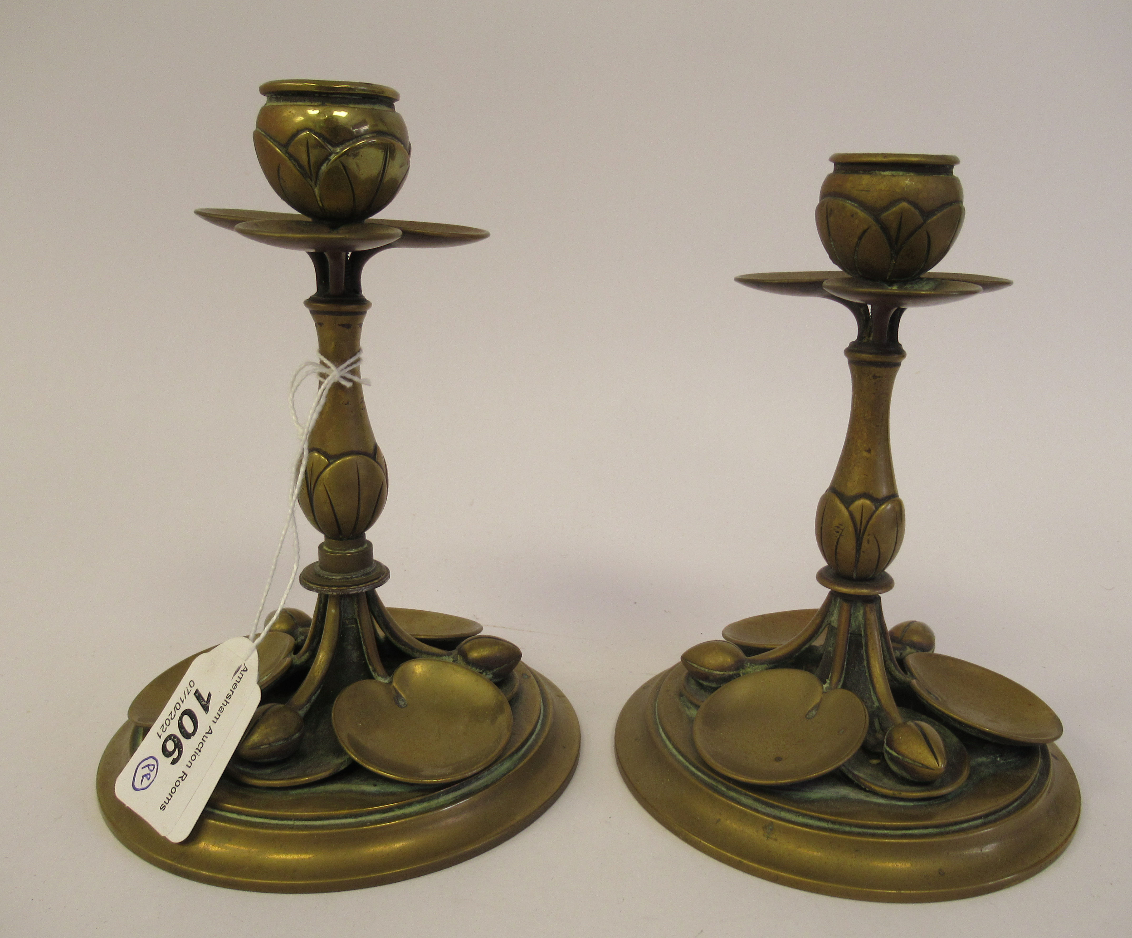 A matched pair of early 20thC Art Nouveau brass candlesticks, naturalistically cast with stylised