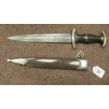A German SA dagger, the moulded brown stained wooden handle with a spreadeagle swastika emblem,