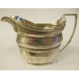 A late 18th/early 19thC silver cream jug of stepped and tapered rectangular outline with bands of