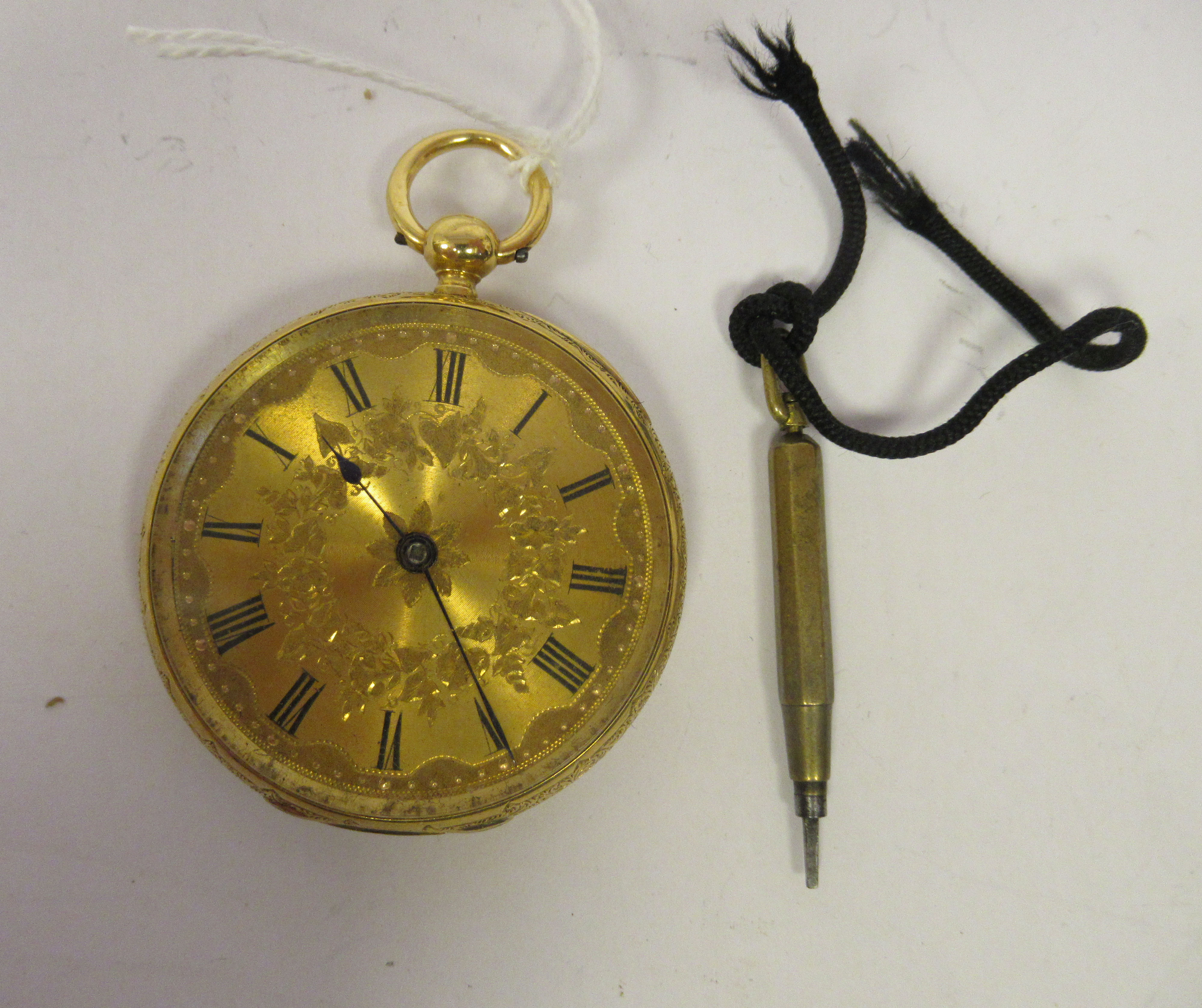 A lady's 18ct gold cased pocket watch with engraved decoration, faced by a finely engine turned