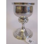 An Omar Ramsden spot-hammered silver trophy cup, the bowl having an upstand rim, over a bulbous