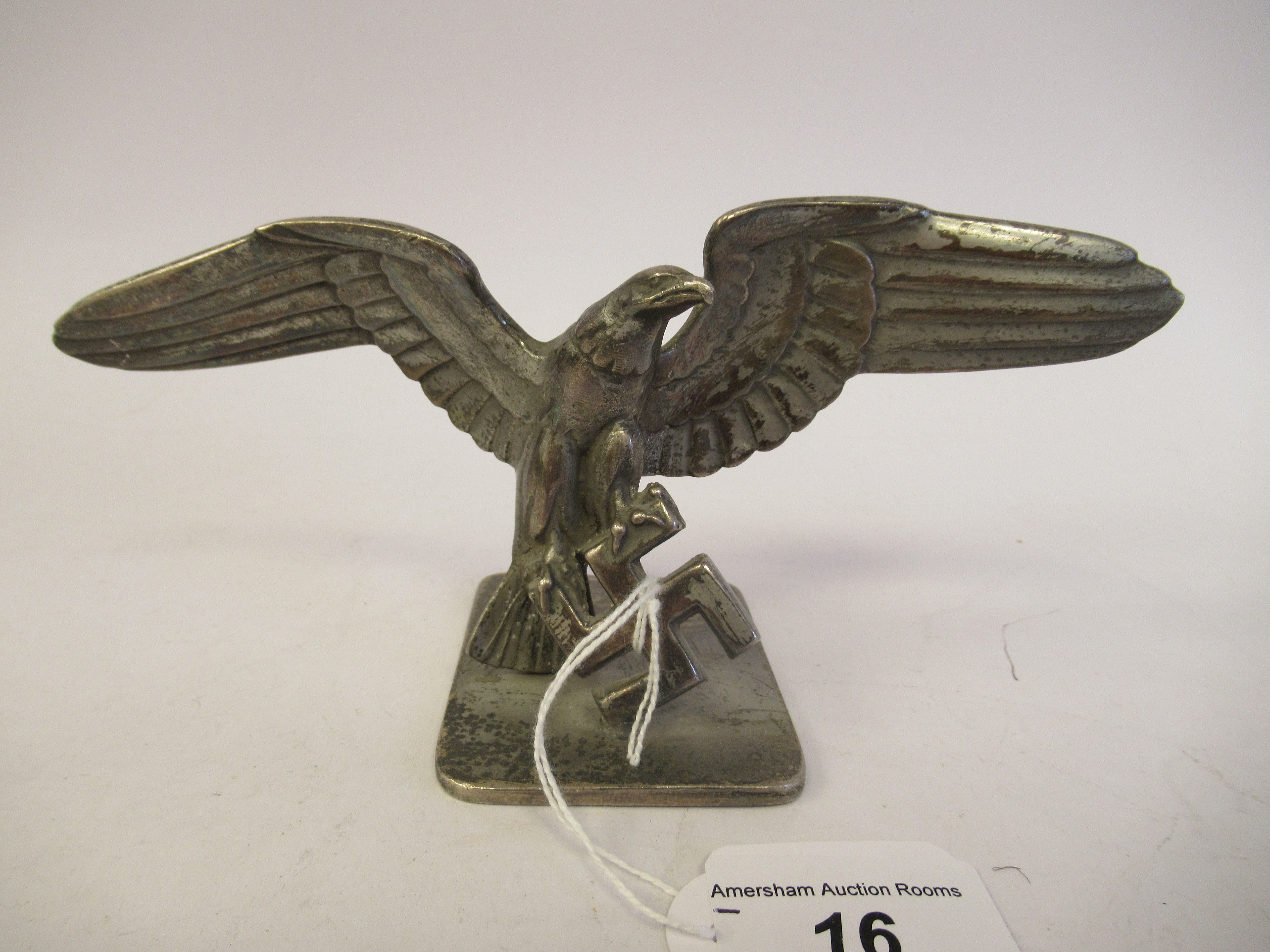 A German World War II silvered aluminium desktop emblem, an eagle alighting upon a swastika  4''