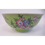 A late 19thC Chinese porcelain footed bowl, decorated in flora and foliage, on a uniformly scroll
