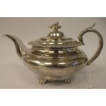 A George III silver teapot of demi-reeded squat, bulbous, oval form with gadrooned and cast