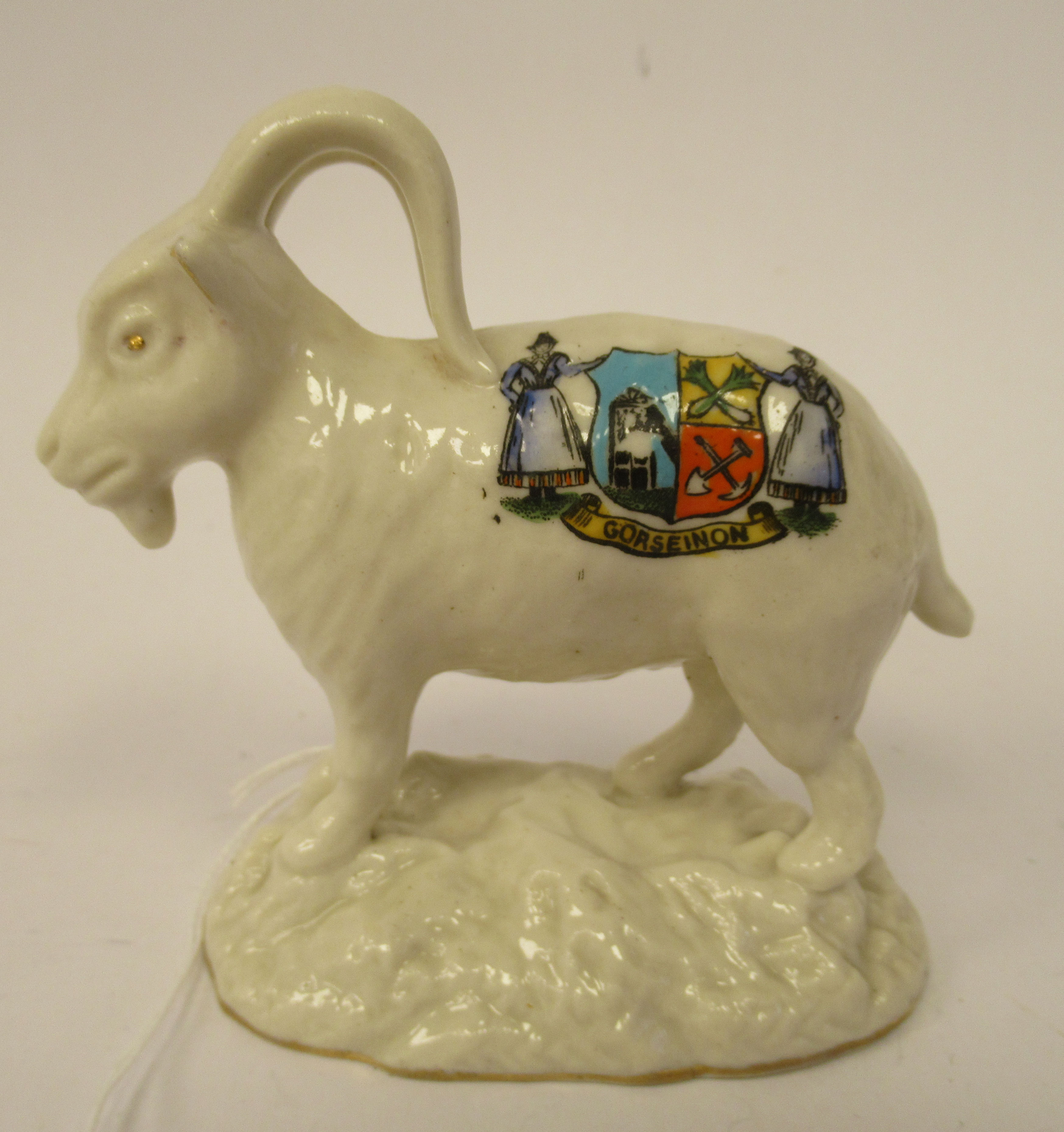 An early 20thC W & R Carlton China crested model, a standing ram, bearing the banner and crest of