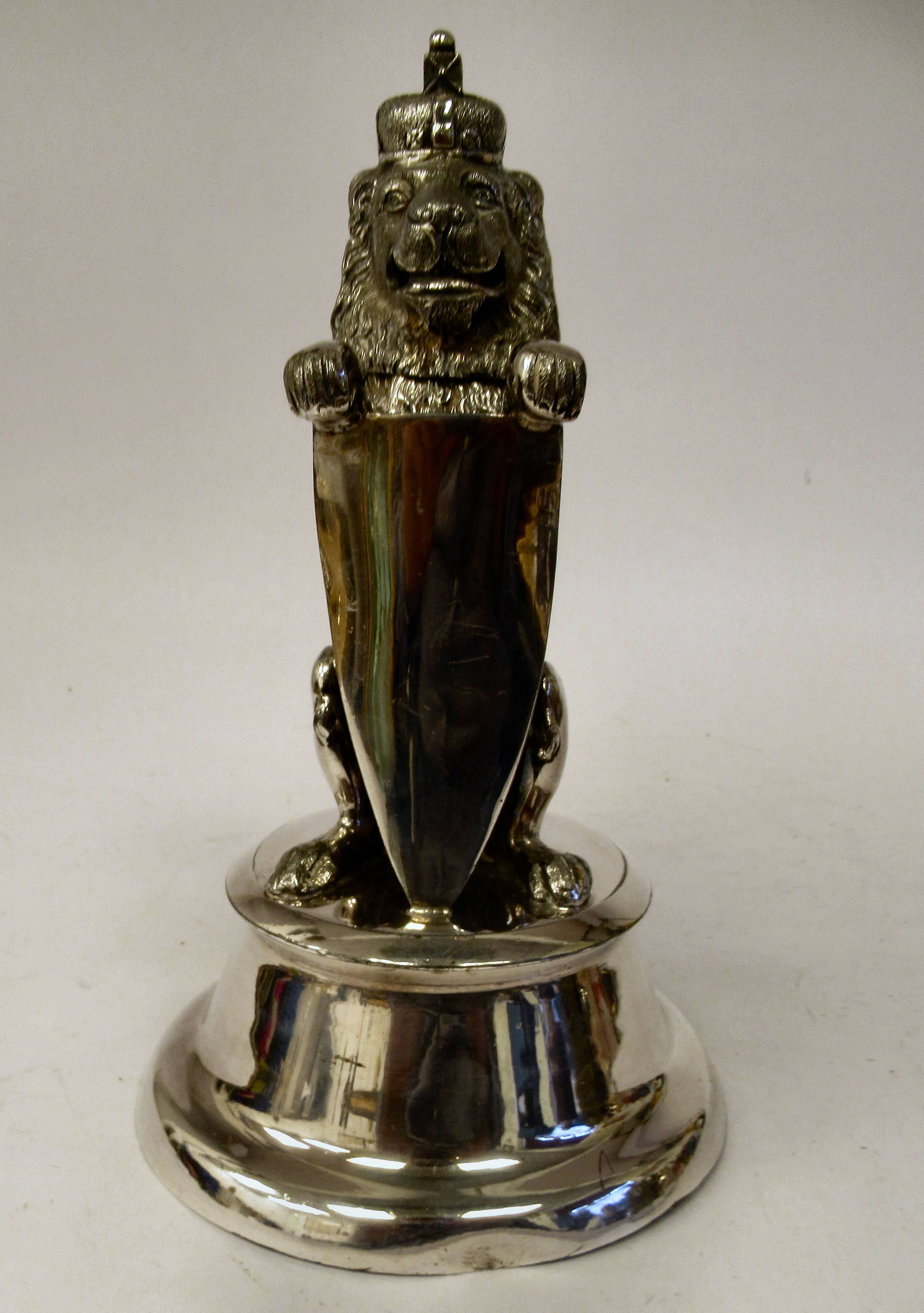 An early 20thC silver plated novelty inkwell and pen holder, fashioned as a crowned heraldic lion