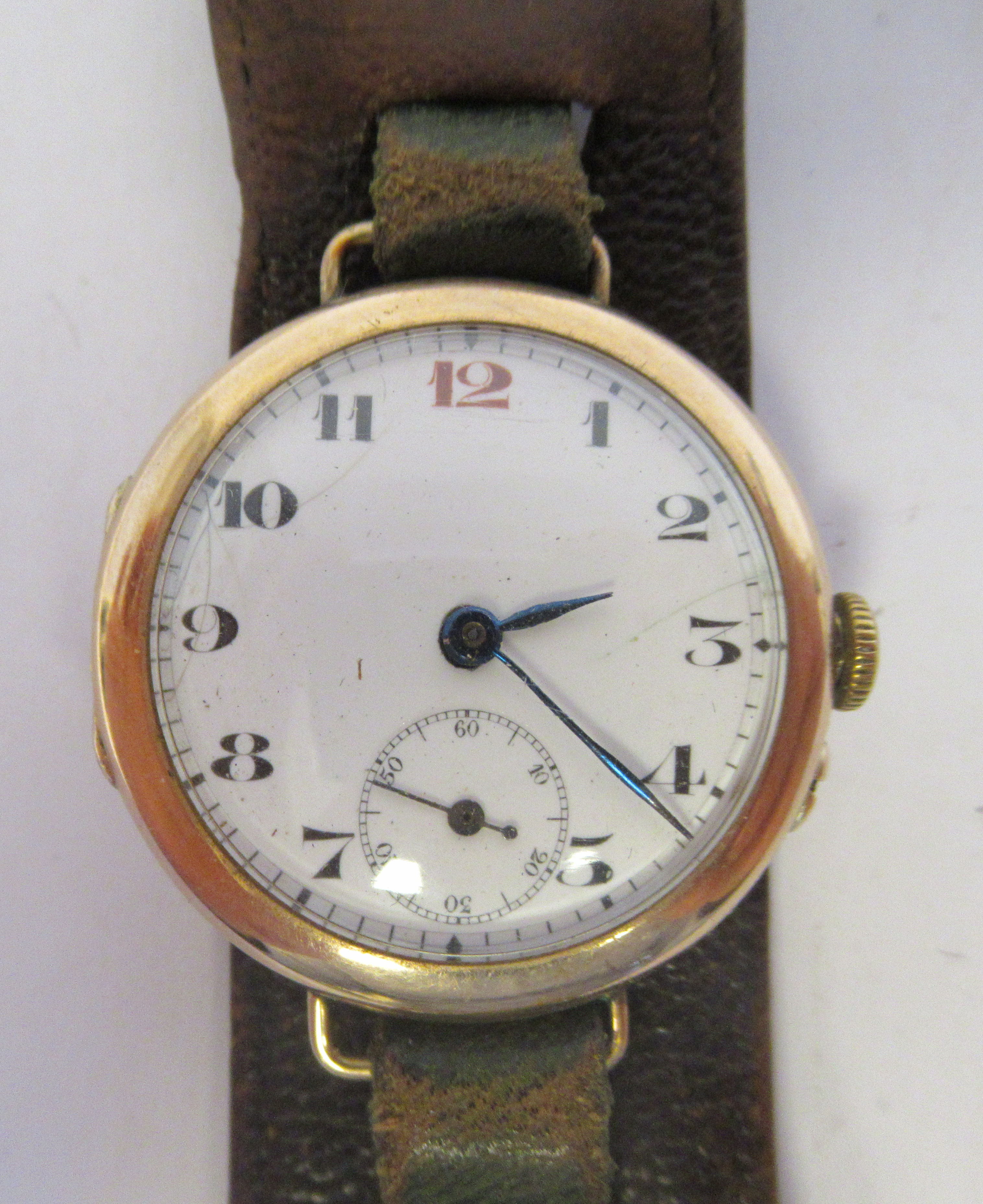 An early 20thC French officer's 9ct gold cased watch, faced by a white enamel Arabic dial,