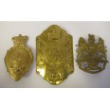 A Royal Artillery shako plate; a stove pipe shako plate; and a coat of arms helmet plate  (Please