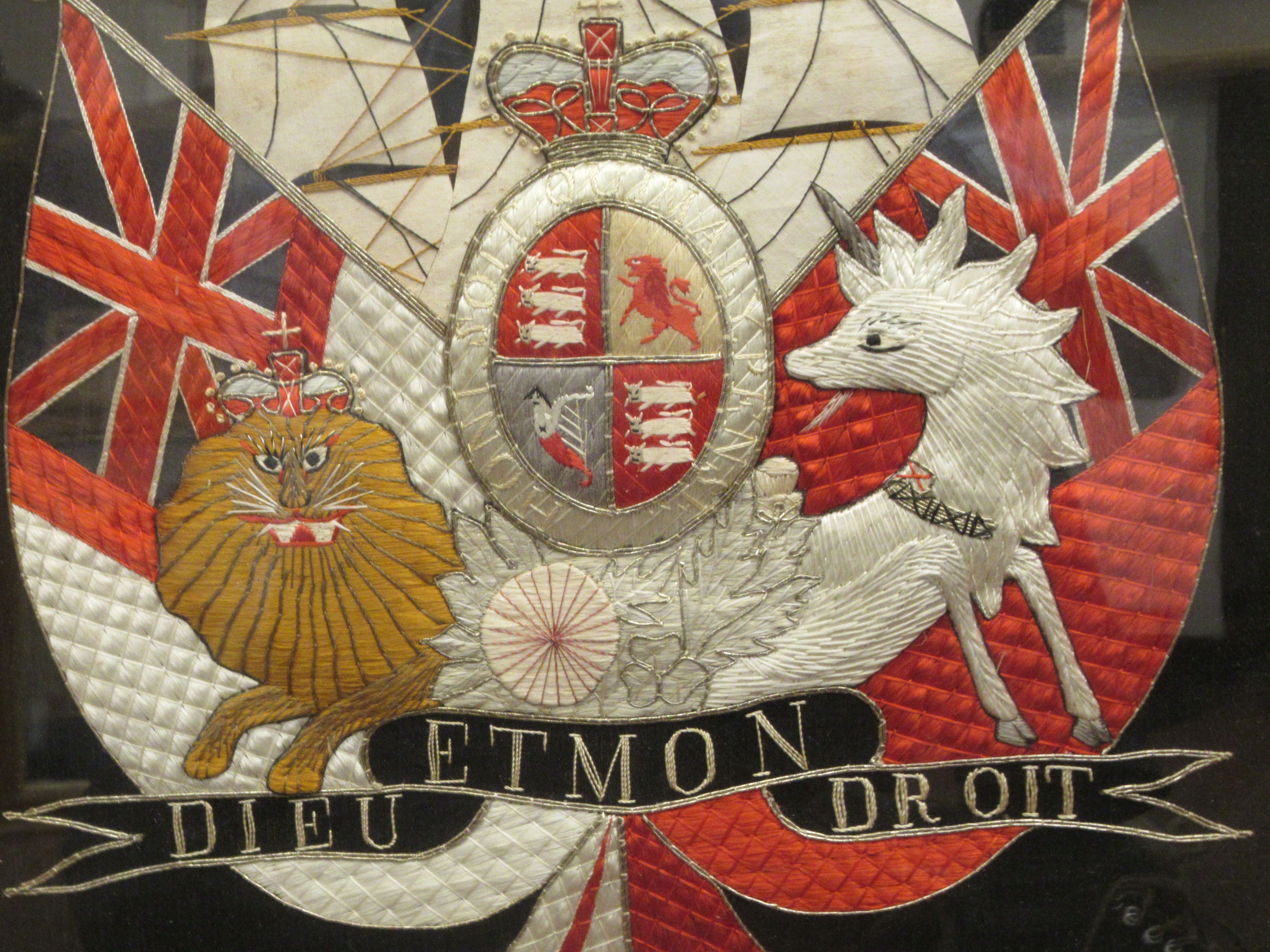 A late 19thC multi-coloured silk tapestry, depicting a version of the British Royal coat of arms, - Image 2 of 3