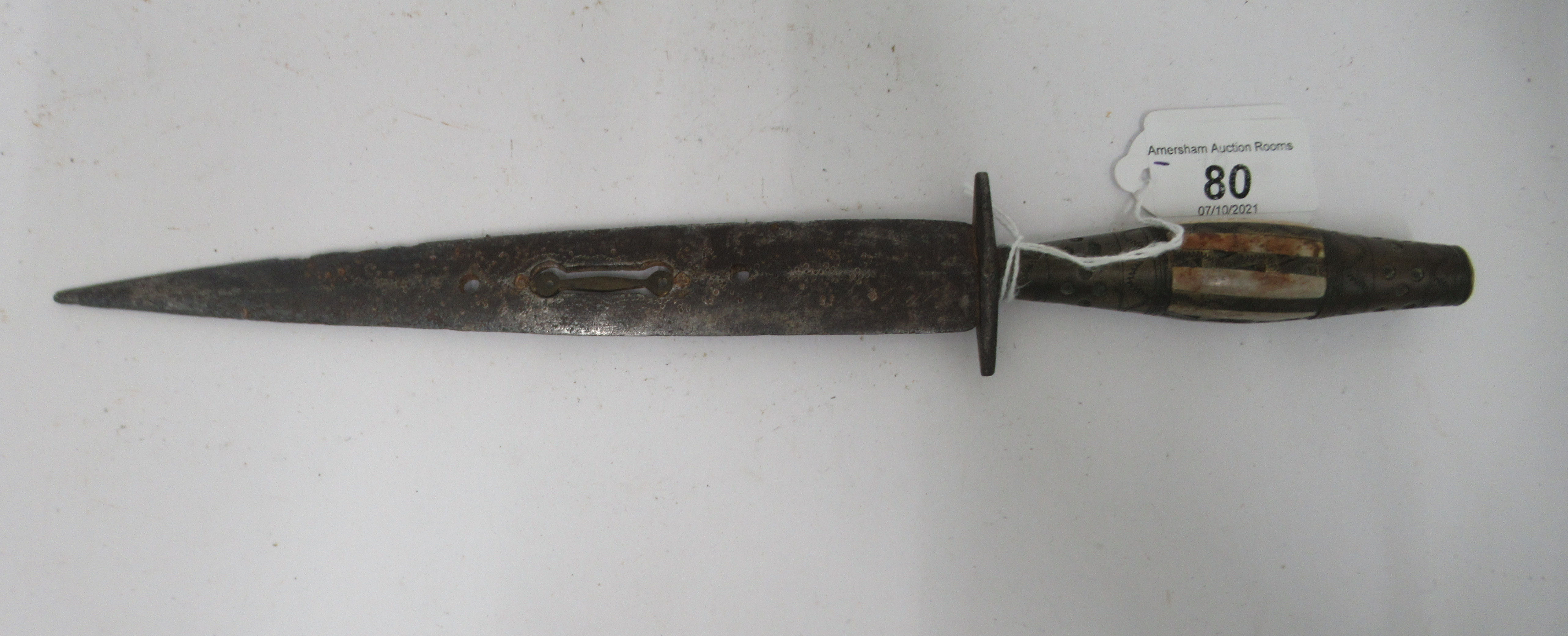 A 20thC Moroccan dagger, the handle set with horn panels  the pierced blade 7.5"L