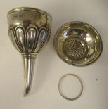A George III silver three part wine funnel, having an applied wire rim, fluted ornament, ring and