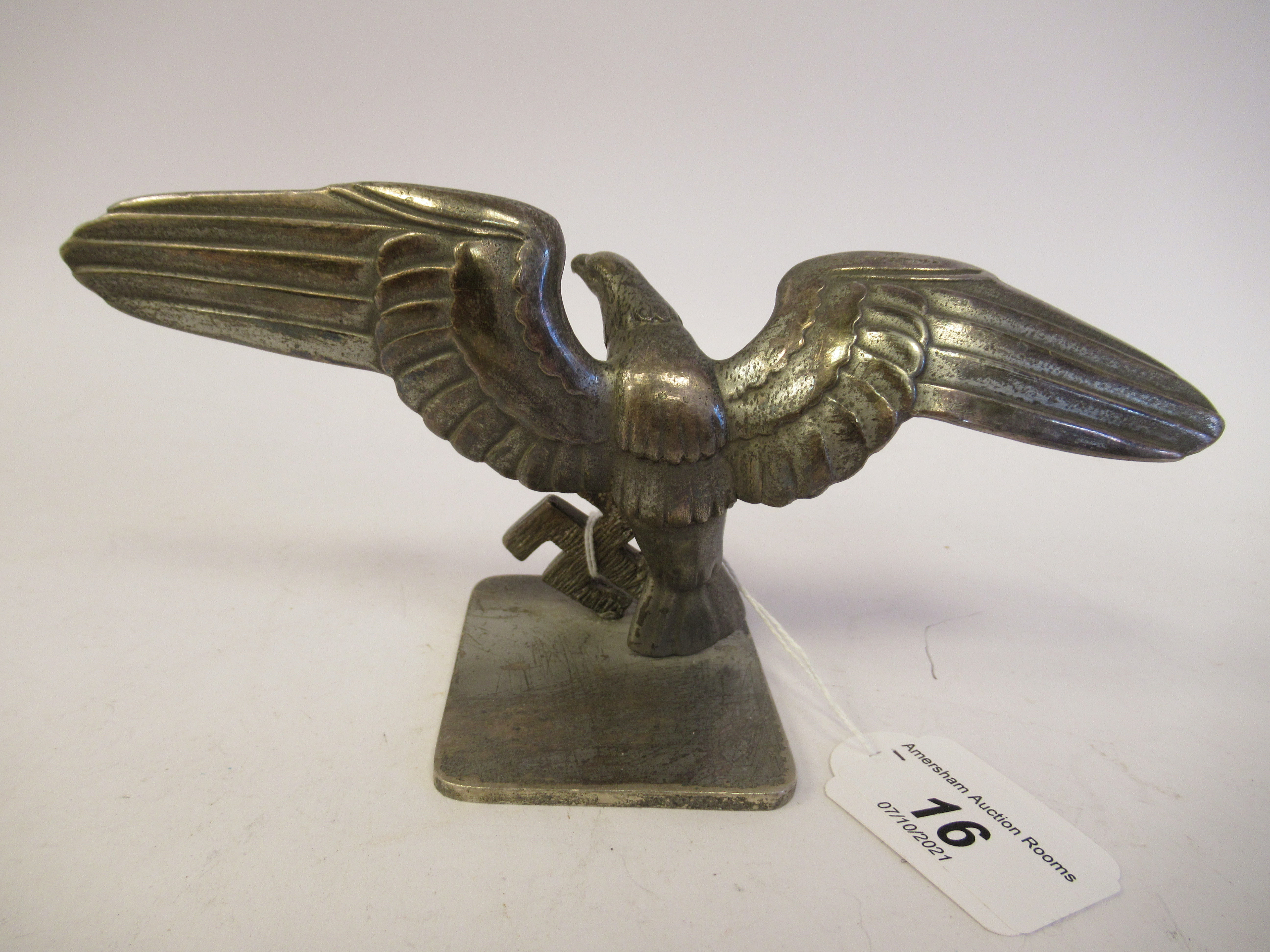 A German World War II silvered aluminium desktop emblem, an eagle alighting upon a swastika  4'' - Image 2 of 4