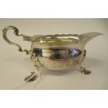 An Edwardian silver sauce boat with a decoratively cut, flared, wavy rim, a shell and acanthus, C-