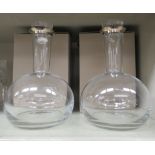 Two (as new) Georg Jensen blown glass, bulbous decanter with an applied silver rim and solid stopper