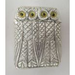 A silver plated vesta case, fashioned as a pair of owls, on a strike plate