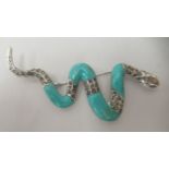 A silver snake brooch, set with turquoise and marcasite