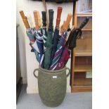 Umbrellas and walking aids, in a twin handled stoneware vase  14"h