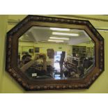 A 1930s mirror, the octagonal bevelled plate set in an oak frame  37" x 27"