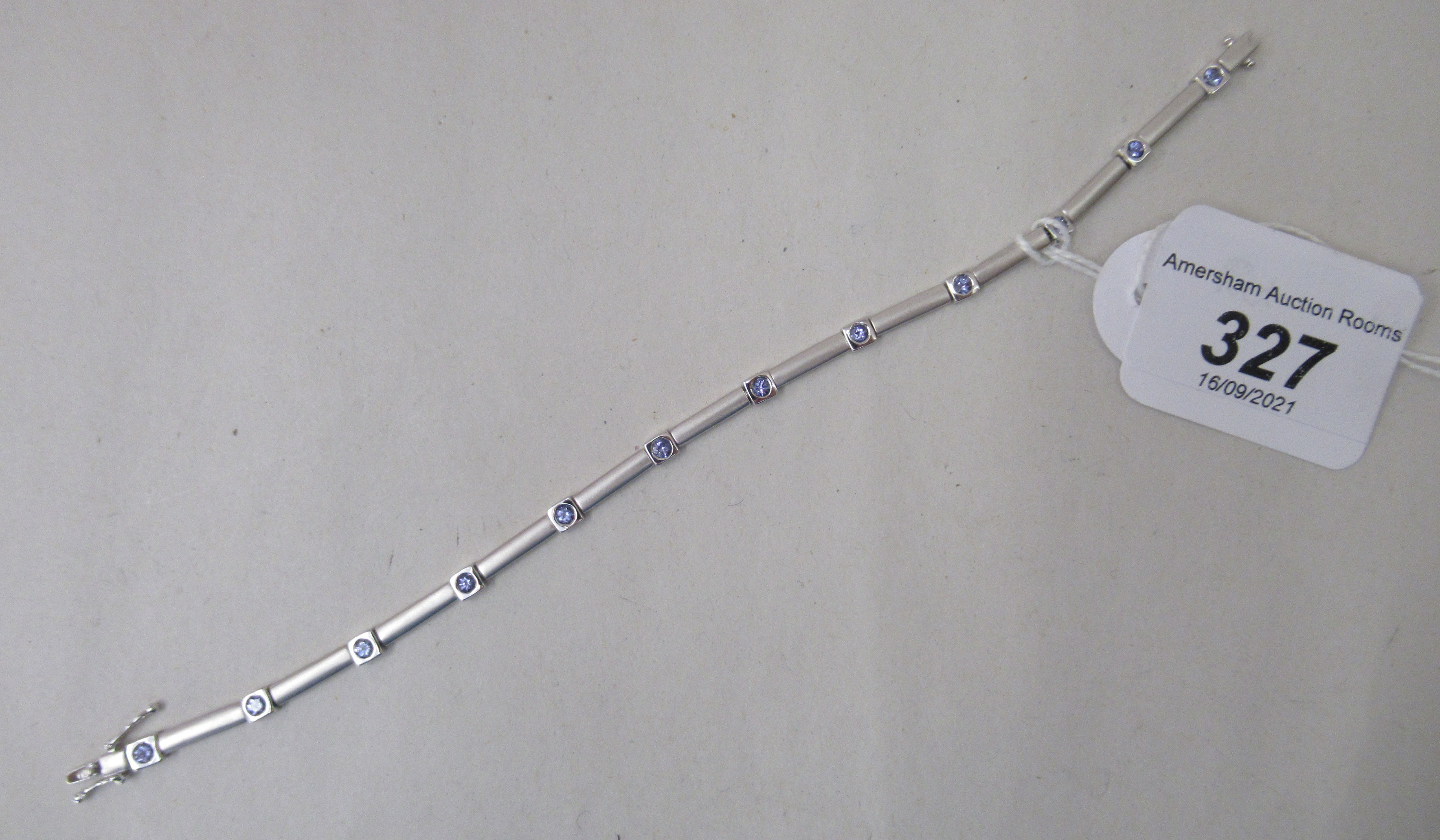 An 18ct white gold multi-link bracelet, set with light blue coloured stones