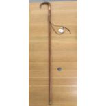 A late 19thC Malacca walking cane with a horn crook handle, rose coloured metal ferrule and an