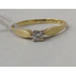An 18ct gold single stone, claw set diamond ring