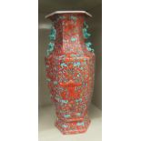 A modern Chinese porcelain vase of hexagonal form, hand painted with stylised designs and text, on