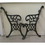 A pair of Victorian style black painted cast iron bench ends