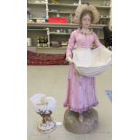 A Robinson & Leadbeater pottery figure, a girl wearing a pinafore dress  29"h; and a Royal Worcester