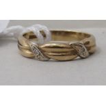 A 9ct gold and diamond set band ring