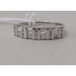 An 18ct white gold ring set with alternating horizontal and vertical panels of line cut diamonds