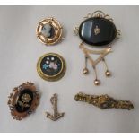Six Victorian and later gold and yellow metal mourning and other brooches: to include a 15ct gold