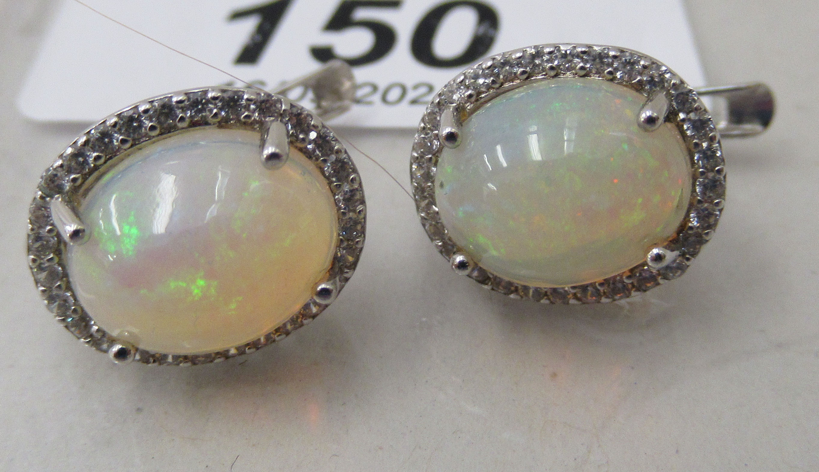 A pair of claw set, opal, cubic zirconia and silver earrings