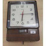 A Seiko Transistor composition wood effect cased battery wall clock; faced by an Arabic dial,