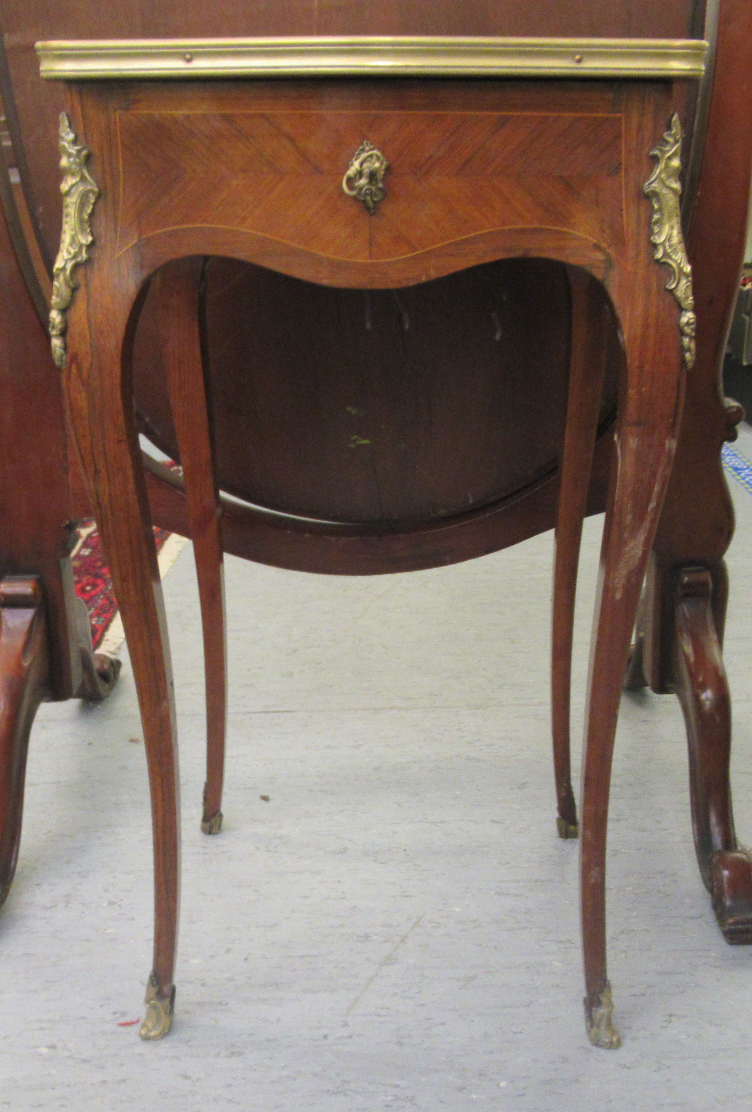 A late 19thC Continental kingwood and marquetry, serpentine outlined vanity table, the hinged top