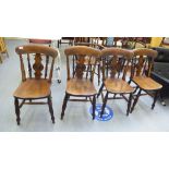 A set of four late Victorian beech and elm framed Windsor chairs, each with a spindled and roundel