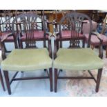 A pair of 19thC Georgian elbow chairs with carved and moulded round backs, waisted splats and open