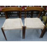 A pair of 1970s teak framed chairs, the woven rush seats raised on tapered legs